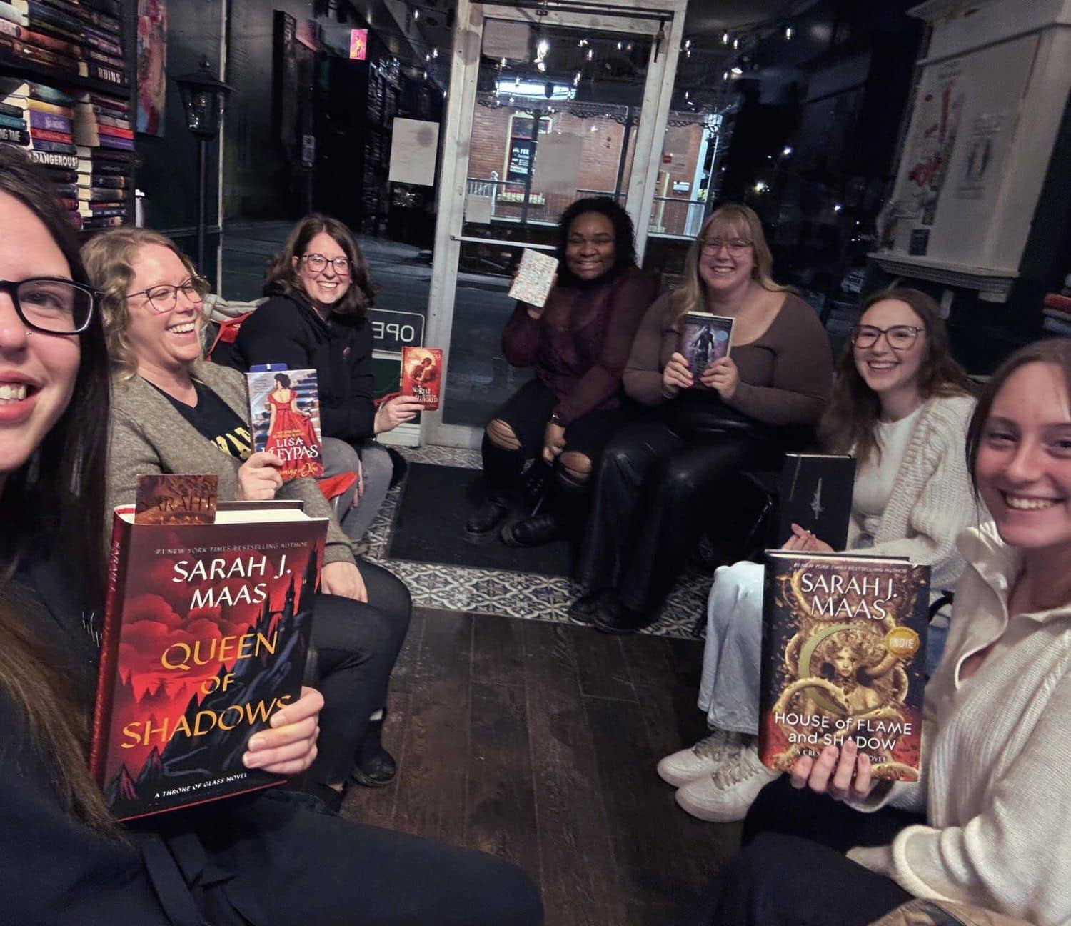 Silent book club readers in candlelight.