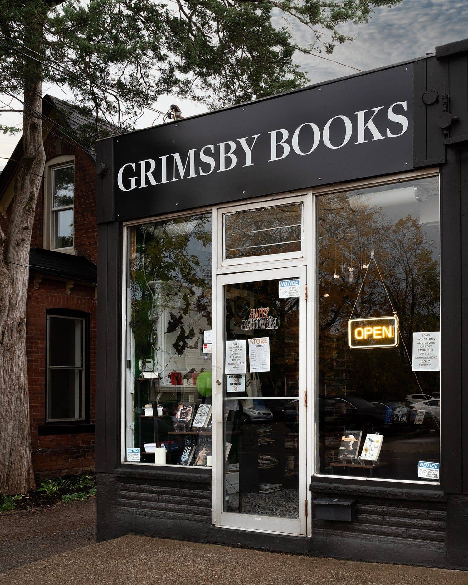 Black-painted Grimsby Books storefront with white serif sign.